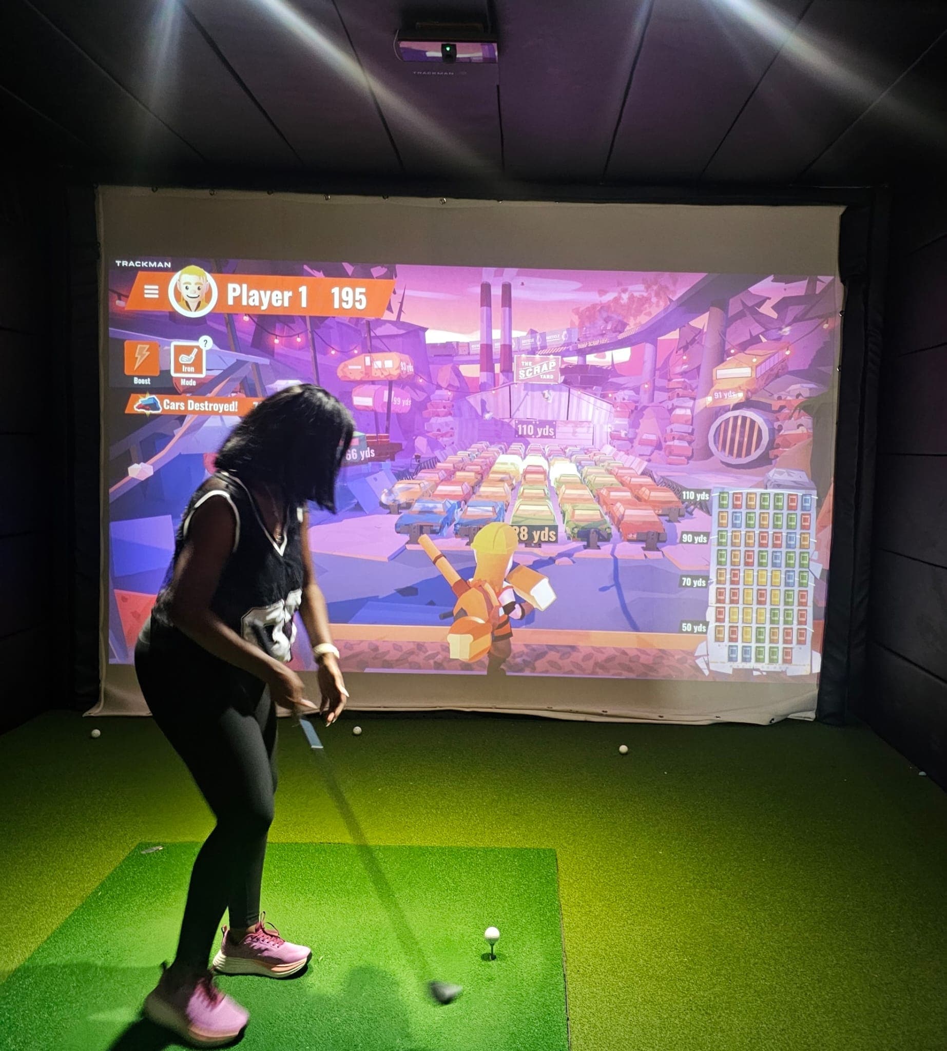Real guest swinging driver at Enzo Golf TrackMan iO Bay 1