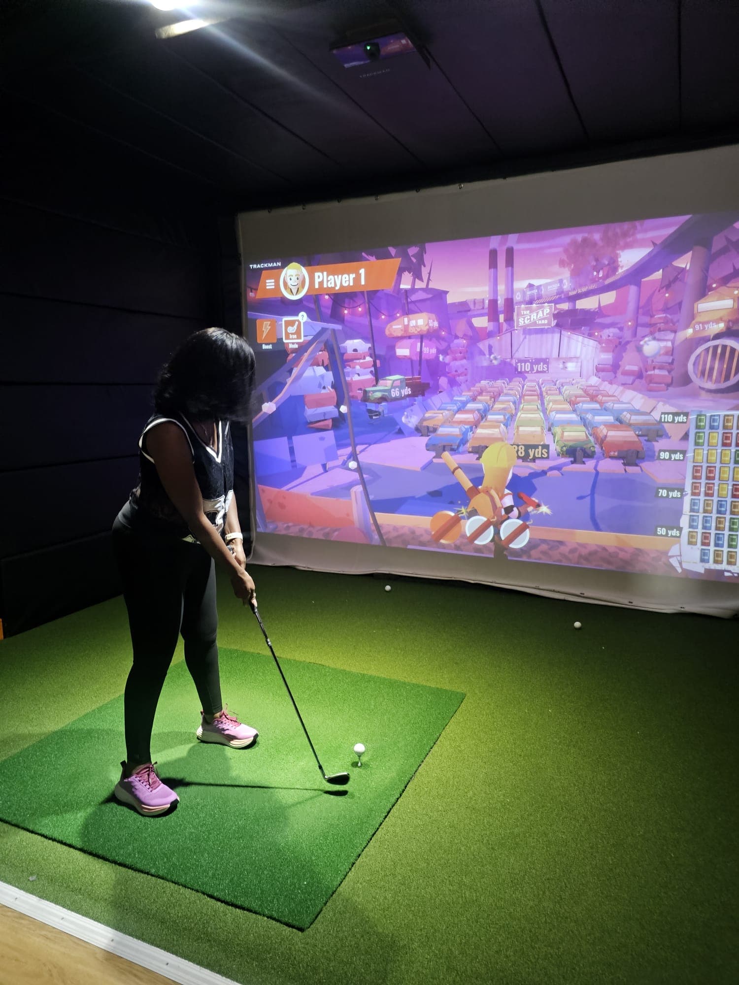 Player enjoying simulator session inside Enzo Golf Guildford